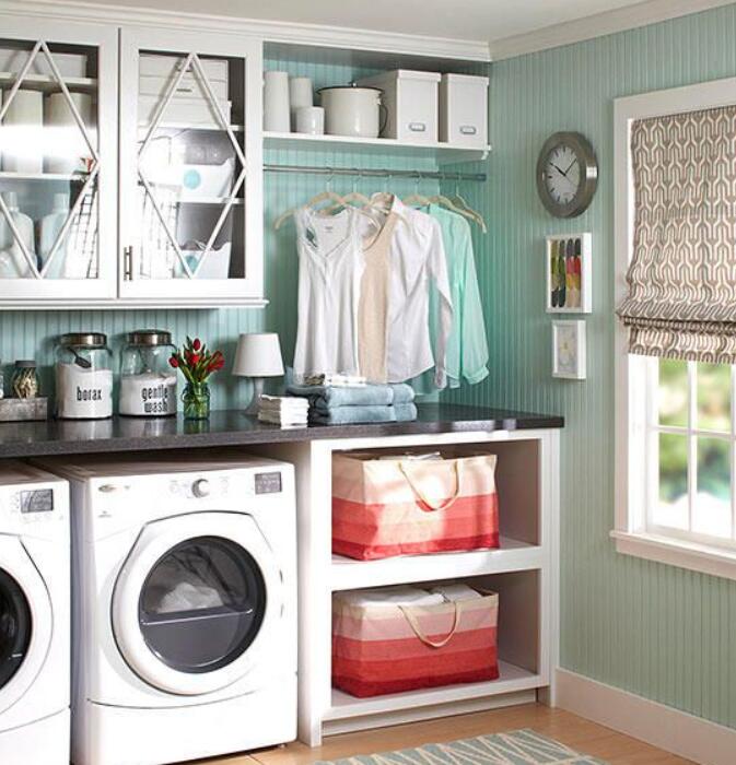 laundry room with cabinets and hanging rods for young couples