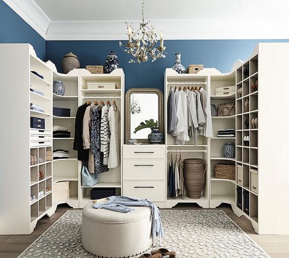 walk in closet with dresser and ottoman