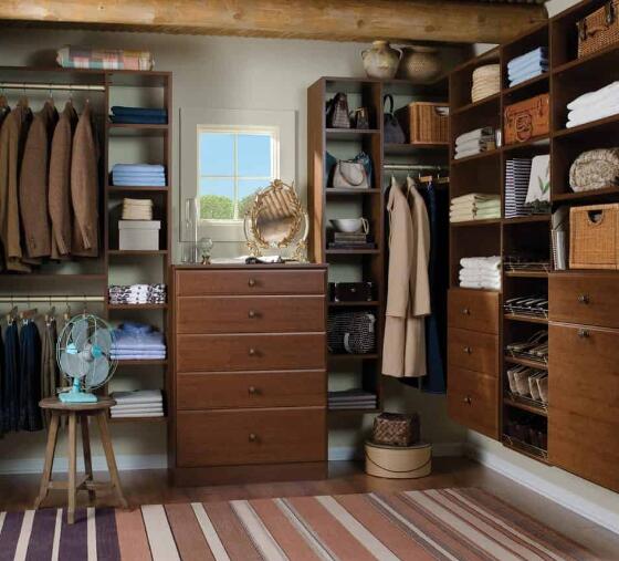 wood walk in closet with dresser